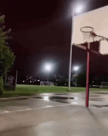 a basketball court is lit up at night with a sign that says ' billy ' on it