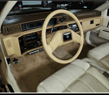 the inside of a car with a steering wheel that says cadillac on it