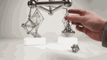 a person is playing with a toy that looks like a balance scale