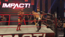 two men in a wrestling ring with the word impact on the bottom