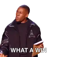 a man in a black jacket is holding a piece of paper that says what a win on it