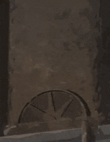 a cartoon character is standing next to a wheel