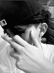 a man covering his face with his hand and the words i trust no one below