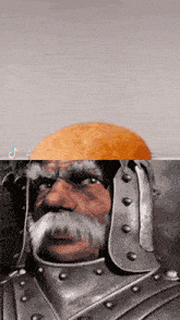 a man with a beard and a helmet has an orange on top