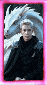 a man in a black cape stands next to a white dragon in a pink frame