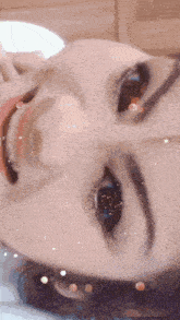 a close up of a woman 's face with sparkles on it