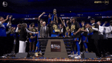 a group of people standing around a podium that has the word finals on it