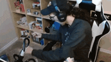 a man wearing a hat and headphones is sitting in a chair