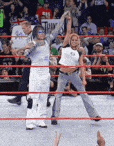 two wrestlers in a ring with one wearing a shirt that says big on it