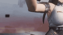 a close up of a woman 's arm in a video game with a gun .