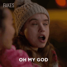 a girl wearing a beanie says oh my god