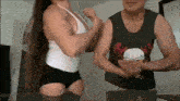 a man and a woman are shaking hands and the man is wearing a shirt with a skull on it .