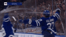 a hockey player with the number 27 on the back of his jersey