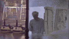 a man in a striped shirt is standing in front of a glass door