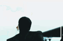 a man with a mustache holds up his fist in the air
