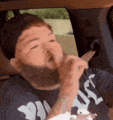 a man with a beard wearing a shirt that says " jesus "