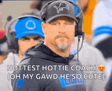a football coach wearing headphones and a hat with a lion on it