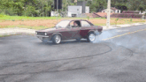 a man driving a car on a road with smoke coming out of it