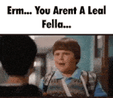 a boy with a bandage on his arm is talking to another boy in a school hallway .