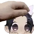 a person is petting a cartoon character 's head with a towel .