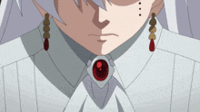 a close up of a person 's face with red eyes and gold earrings