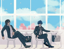 two men in suits sit in front of a large window