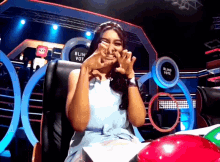 a woman making a face in front of a sign that says blind vote