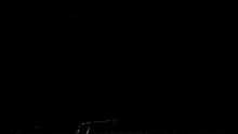 a dark background with a few lines and a light coming out of the bottom