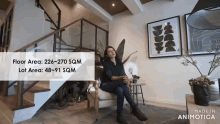 a woman sits in a chair in front of a staircase and a sign that says made in animatica