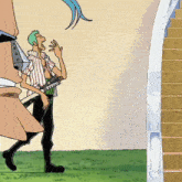 a man in a striped shirt is standing next to a staircase