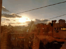 a view of a sunset through a window with a reflection of a building