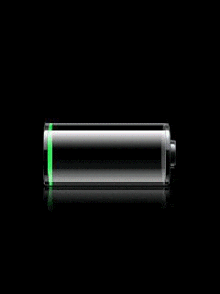 a green battery is sitting on a black surface with a reflection of it .