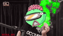 a man wearing a black shirt with occupy on it
