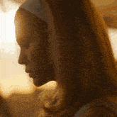 a woman wearing a headband looks down at something