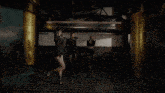 three women are standing next to each other in a dark room