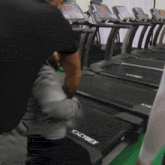 a row of treadmills with the word cybex on the side