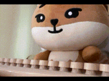 a stuffed animal is sitting on a keyboard with a black nose