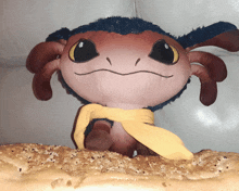 a stuffed animal with a scarf around its neck