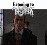 a man in a suit and tie is listening to a band
