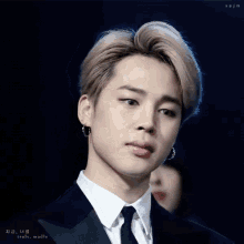 a close up of a man wearing a suit and tie with the words truly madly below him