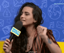 a woman holding a microphone that says multi show