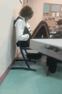 a person sits at a table with their feet up