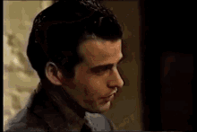 a man and a woman are standing next to each other in a room and talking .