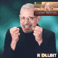 a man wearing glasses and a black shirt is holding his fist up in the air