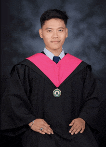 a man in a graduation gown has a medal around his neck that says ' university of the philippines '