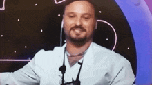 a man with a beard wearing a white lab coat and a hat