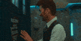 a man in a suit and tie says hi chat in a dark room