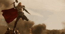 thor is flying through the air holding a hammer .