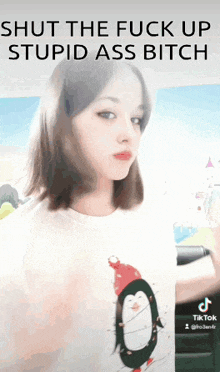 a girl is wearing a penguin t-shirt and the caption says shut the fuck up stupid ass bitch