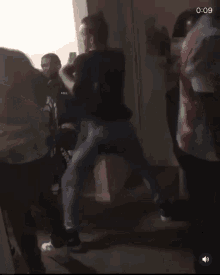 a group of people are dancing in a room with a man wearing a headband that says nike